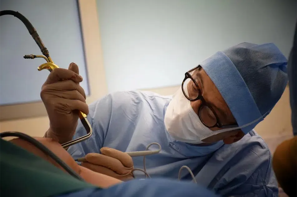 A surgeon performing breast augmentation