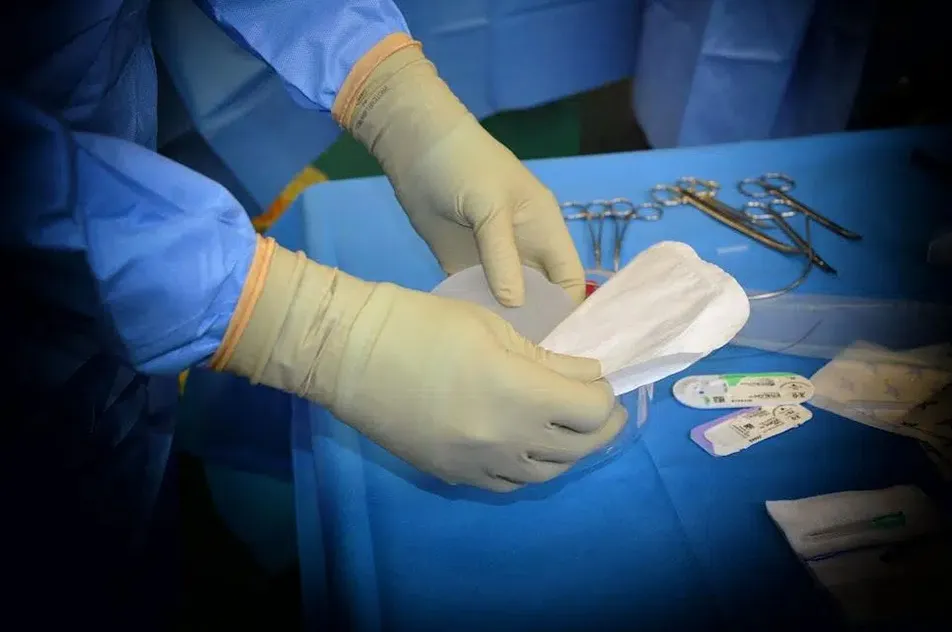 Surgeon Conducting Breast Re-Augmentation Surgery